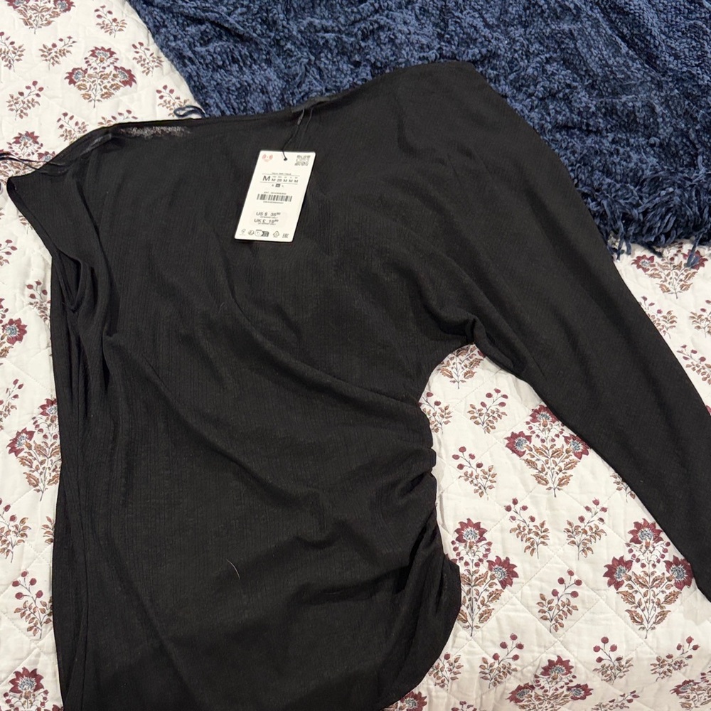 Zara’s asymmetrical sheer top